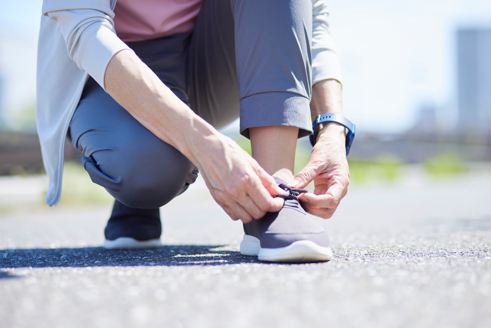 ランニングシューズの紐を結んでいる様子
